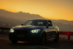 white and black bmw m 3 on road during sunset